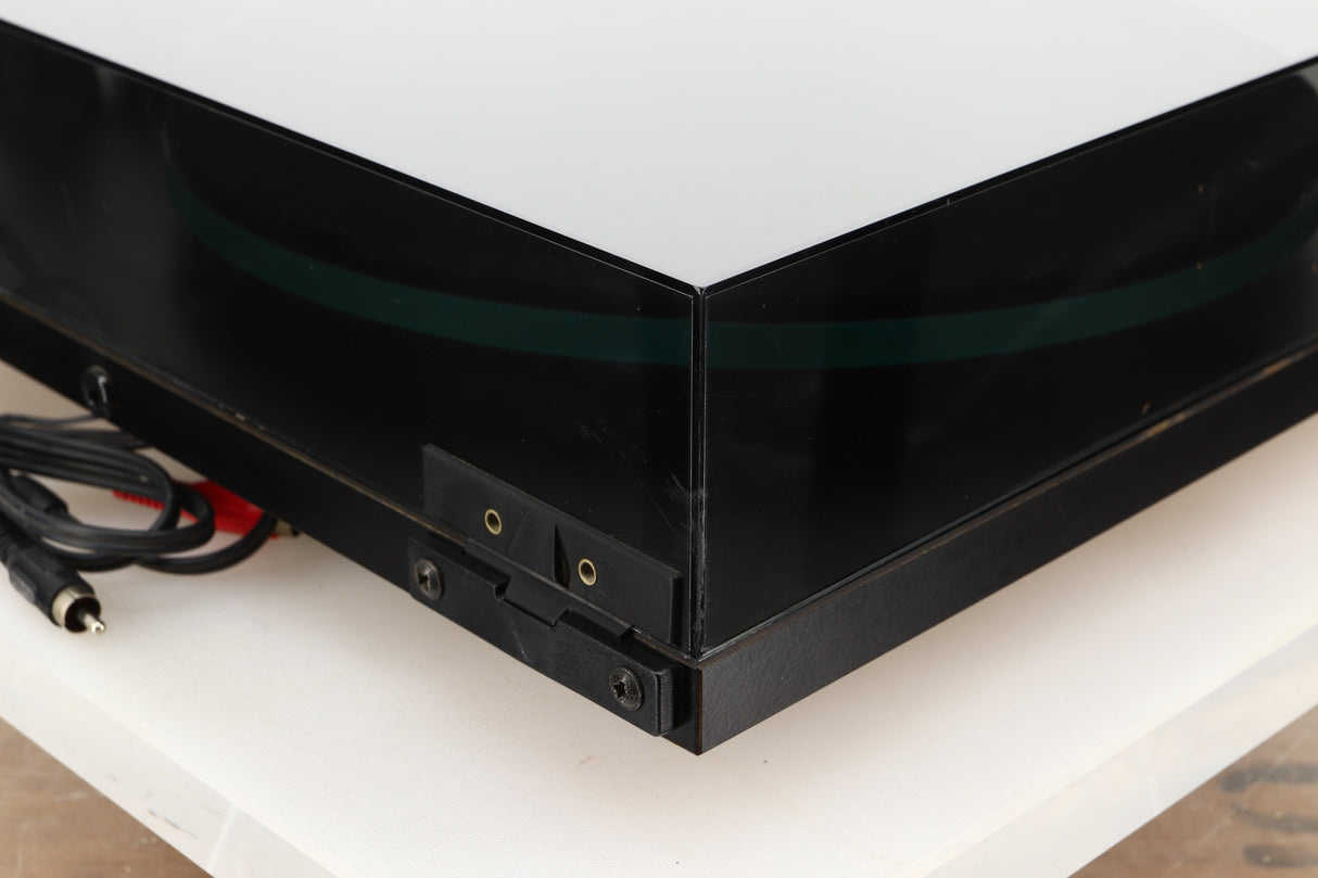 Rear left corner of a used Rega Planar 3 (24V Upgraded) Turntable / Goldring E3 Cartridge in a black finish