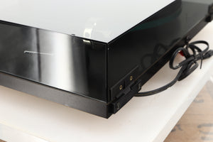 Rear right corner of a used Rega Planar 3 (24V Upgraded) Turntable / Goldring E3 Cartridge in a black finish