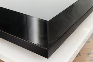 Front left corner of a used Rega Planar 3 Turntable 24V Upgraded in a black finish