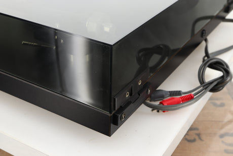 Rear right corner of a used Rega Planar 3 Turntable 24V Upgraded in a black finish