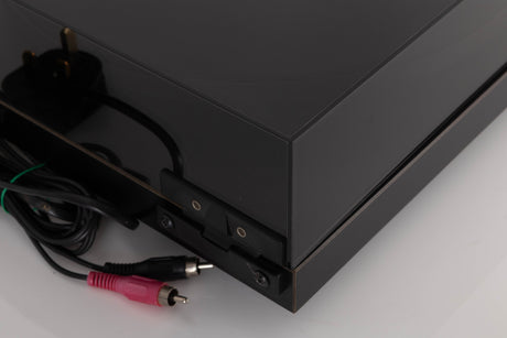 Rear left corner of a used Rega Planar 3 Turntable W/ Nagaoka MP11 Boron Cartridge in a Black finish