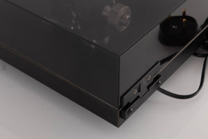 Rear right corner of a used Rega Planar 3 Turntable W/ Nagaoka MP11 Boron Cartridge in a Black finish