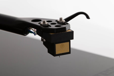 Close up of a used Rega Planar 3 Turntable W/ Nagaoka MP11 Boron Cartridge in a Black finish showing stylus