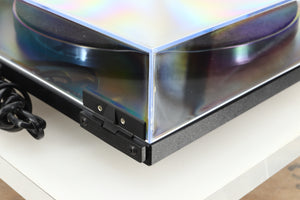 Rear left corner of a used Rega Planar RP1 Turntable in a cool grey finish