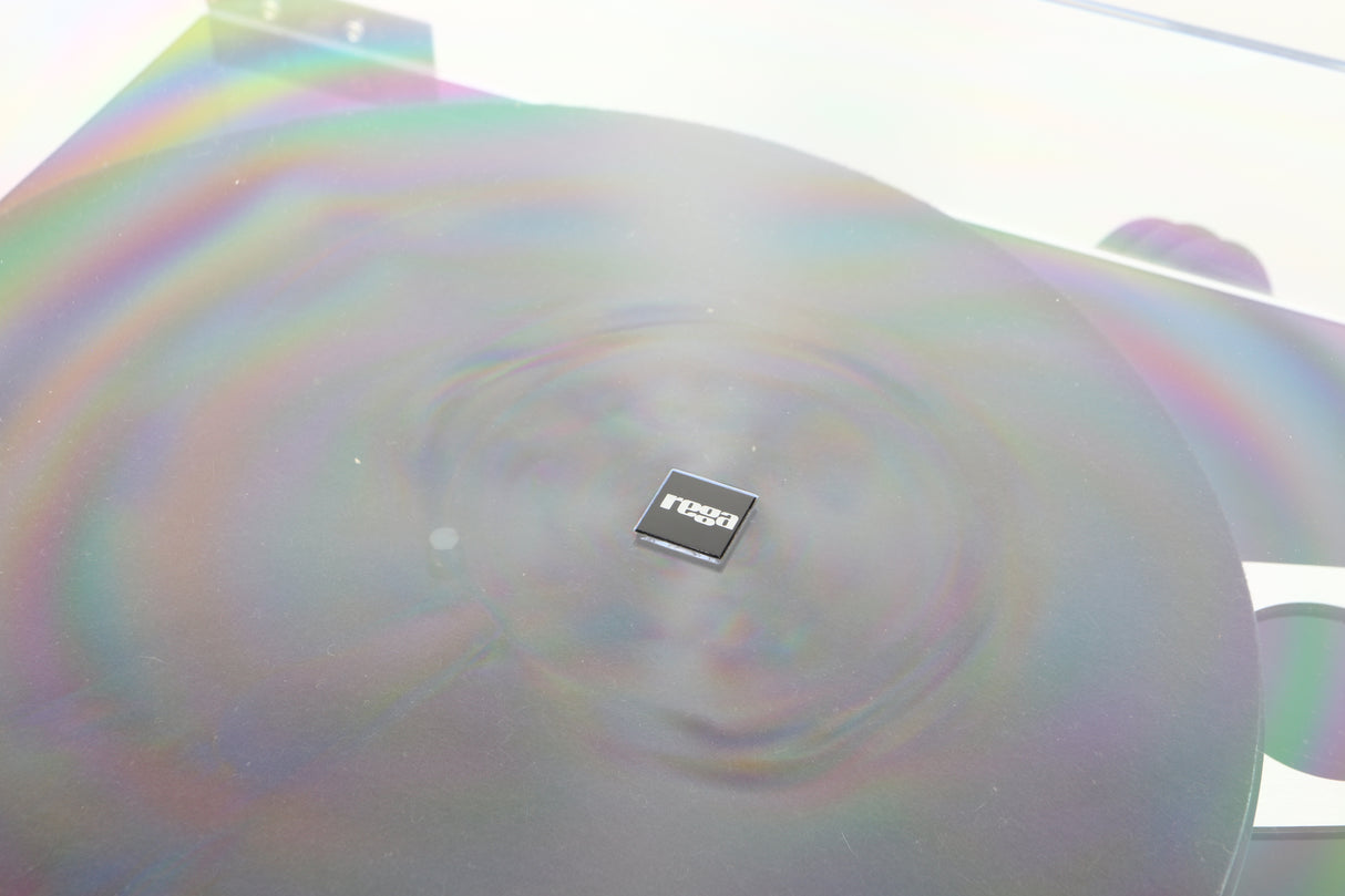 Close up of a used Rega Planar 3 Turntable / Exact Cartridge in a black finish showing scratching around the badge on lid