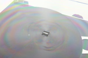 Close up of a used Rega Planar 3 Turntable / Exact Cartridge in a black finish showing scratching around the badge on lid