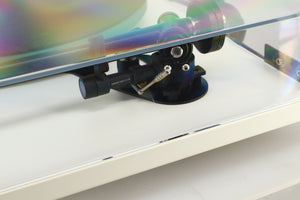 Close up of a used Rega RP3 / Exact Cartridge in a white finish showing scratching on lid