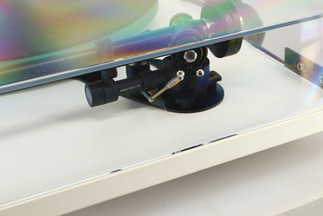Close up of a used Rega RP3 / Exact Cartridge in a white finish showing scratching on lid