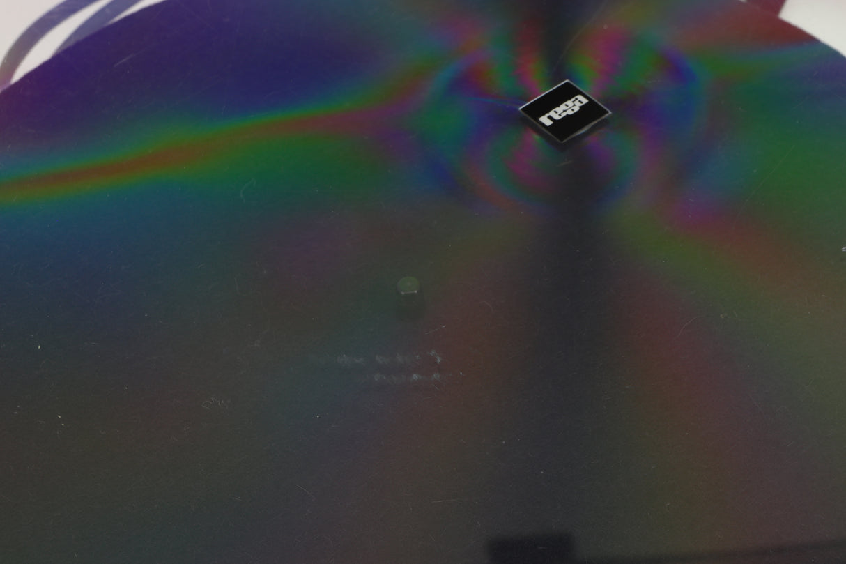 Close up of a used Rega RP3 / Exact Cartridge in a white finish showing scratching on top of lid