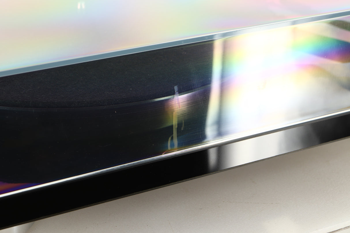 Close up view of a used Rega RP8 Turntable in Black finish showing scratch on the front of the lid