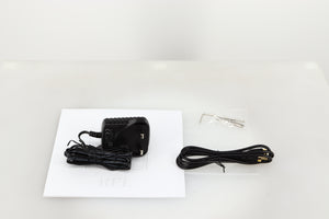 Accessories for a used REL Arrow V3 Wireless Subwoofer Transmitter showing Power Supply, Manual, Allen Key, Bolts and Interconnect Cable 