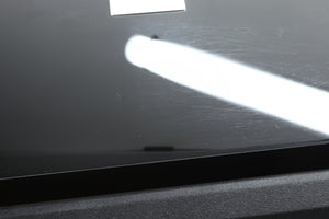 Close up view of a used REL S/3 SHO Subwoofer in Piano Black finish showing scratching on the top 