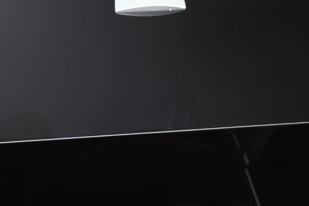 Close up view of a used REL S/3 SHO Subwoofer in Piano Black finish showing scratching on the top 