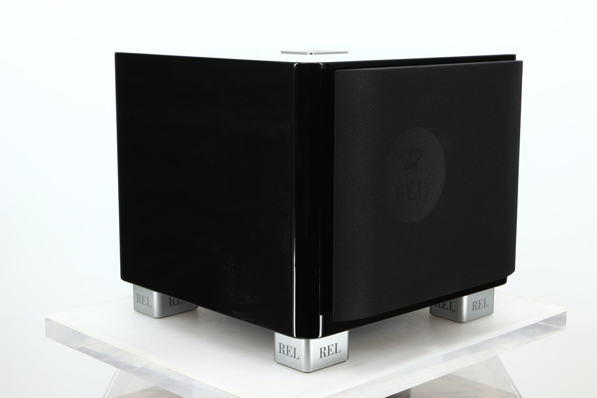 Front left corner of a used REL T-7X Subwoofer in a piano black finish