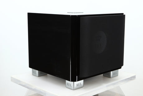 Front left corner of a used REL T-7X Subwoofer in a piano black finish