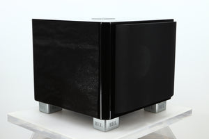 Front left corner of a used REL T-7X Subwoofer in a piano black finish