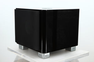 Front right corner of a used REL T-7X Subwoofer in a piano black finish