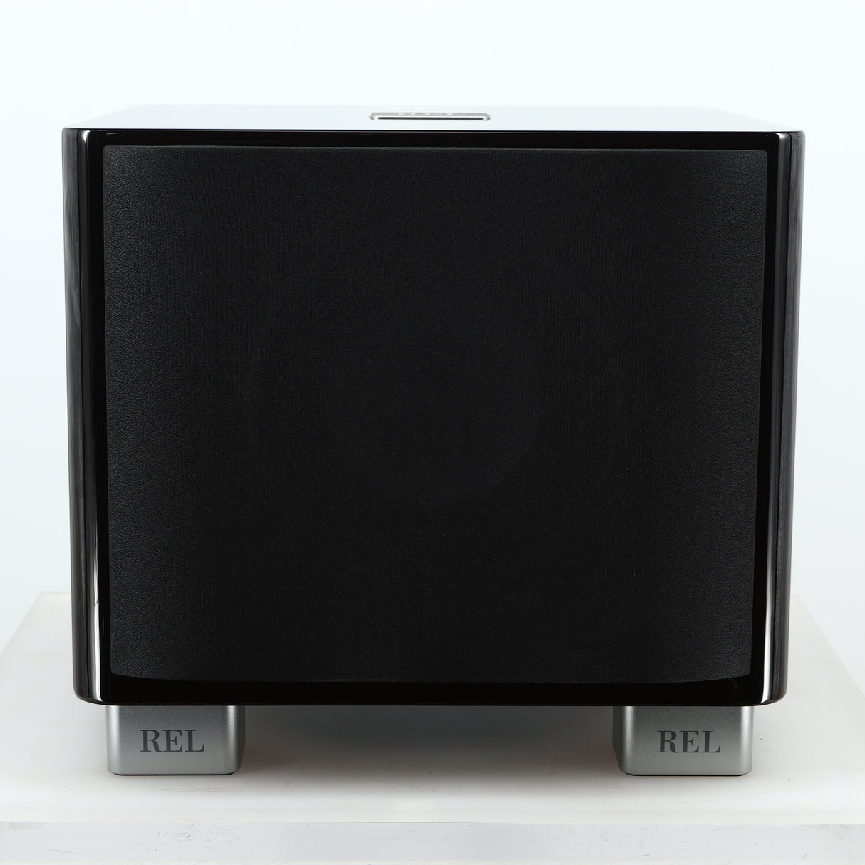 Front view of a used REL T-7X Subwoofer in a piano black finish showing the grille