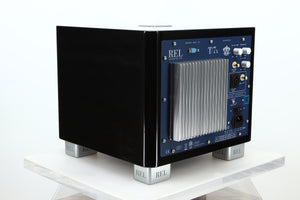 Rear right corner of a used REL T-7X Subwoofer in a piano black finish