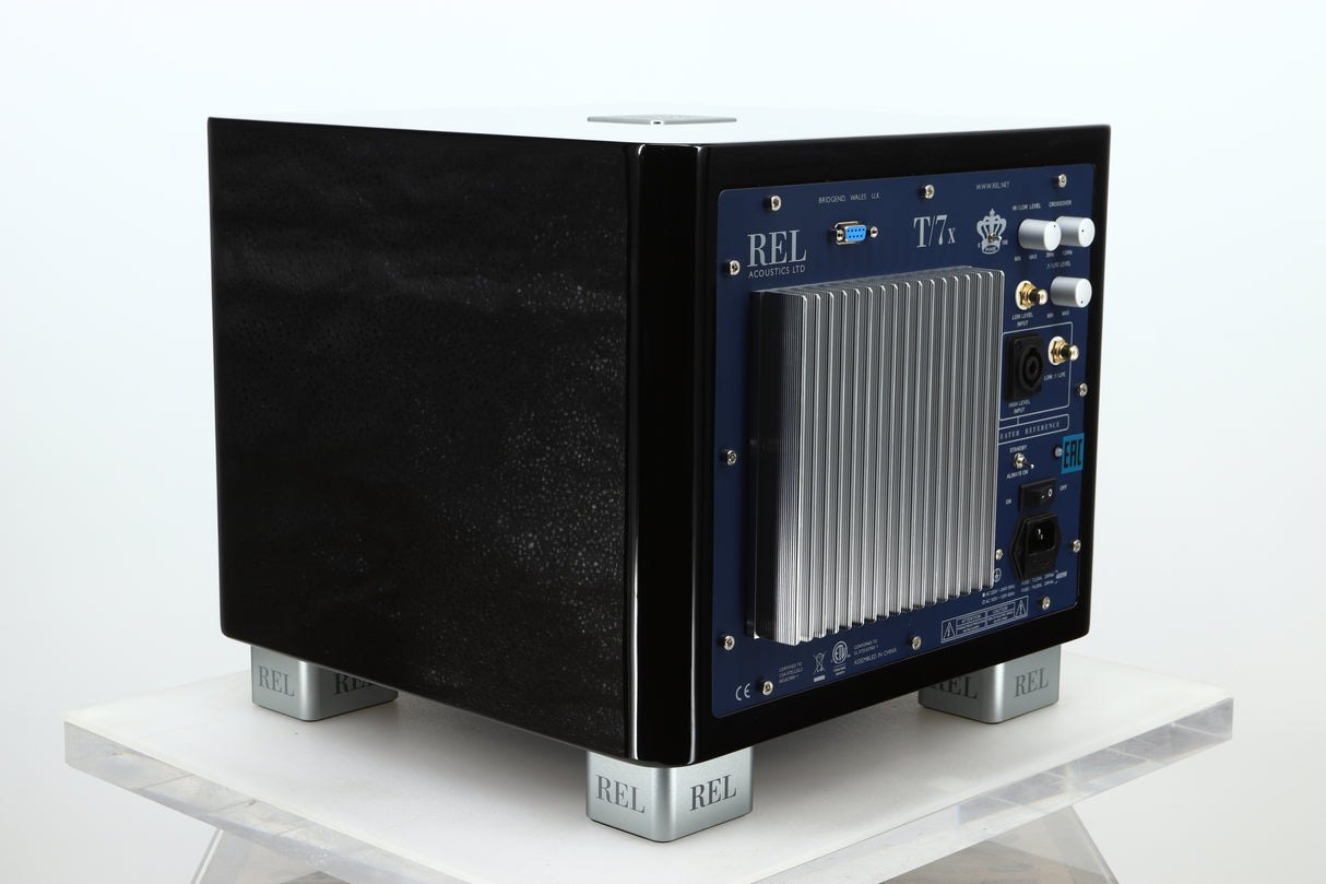 Rear right corner of a used REL T-7X Subwoofer in a piano black finish