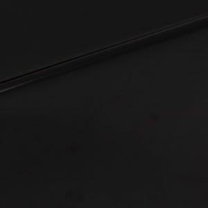 Close up of a used REL T-Zero Subwoofer in a Piano Black finish showing scratch on left side