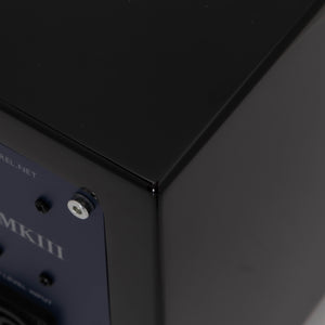 Rear left corner of a used REL T-Zero Subwoofer in a Piano Black finish