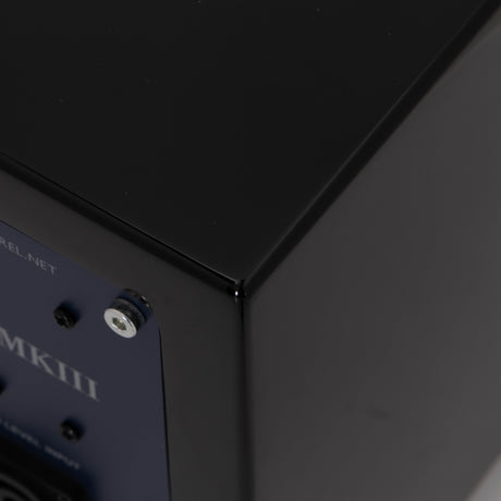 Rear left corner of a used REL T-Zero Subwoofer in a Piano Black finish