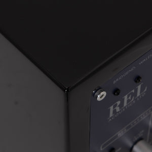 Rear right corner of a used REL T-Zero Subwoofer in a Piano Black finish