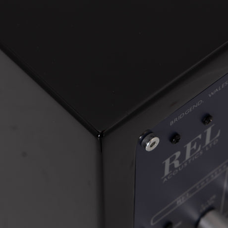 Rear right corner of a used REL T-Zero Subwoofer in a Piano Black finish