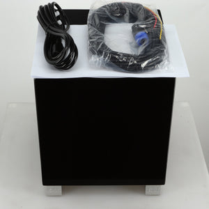 Top view of a REL T5i Subwoofer with a piano black finish showing mains cable, hi-level cable and manual