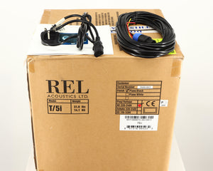 Box for a used REL T5i Subwoofer in a piano black finish showing Hi-Level Cable, Mains Cable and Manual