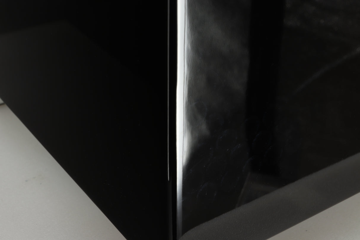 Close up of a REL T5i Subwoofer with a piano black finish showing feet like marks