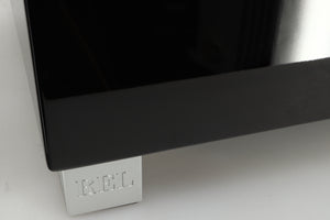 Close up of a REL T5i Subwoofer with a piano black finish showing a small scratch