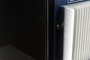 Close up of a used REL T5i Subwoofer in a piano black finish showing scratch on right side