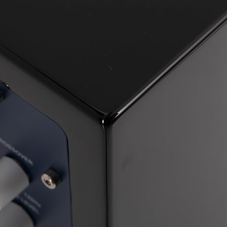 Rear left corner of a used REL T5i Subwoofer in a Piano Black finish