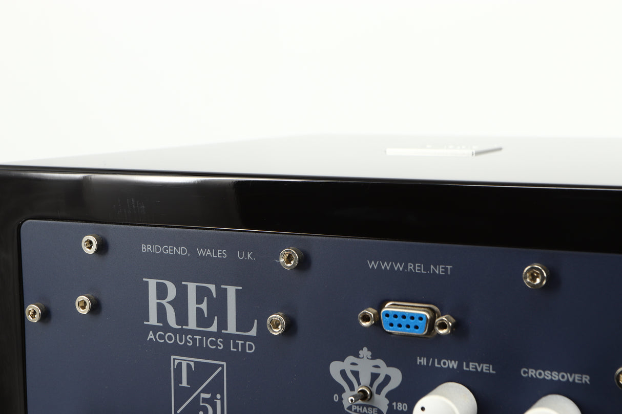 Close up of a used REL T5i Subwoofer W/ Upgraded Feet in a piano black finish showing light scratching on rear edge