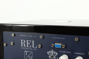 Close up of a used REL T5i Subwoofer W/ Upgraded Feet in a piano black finish showing light scratching on rear edge