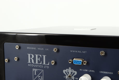 Close up of a used REL T5i Subwoofer W/ Upgraded Feet in a piano black finish showing light scratching on rear edge