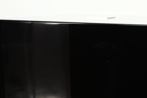 Close up of a used REL T5i Subwoofer W/ Upgraded Feet in a piano black finish showing small nick