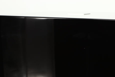 Close up of a used REL T5i Subwoofer W/ Upgraded Feet in a piano black finish showing small nick