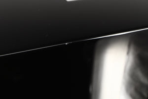 Close up view of a used REL T5i Subwoofer in Piano Black finish with Upgrade Feet