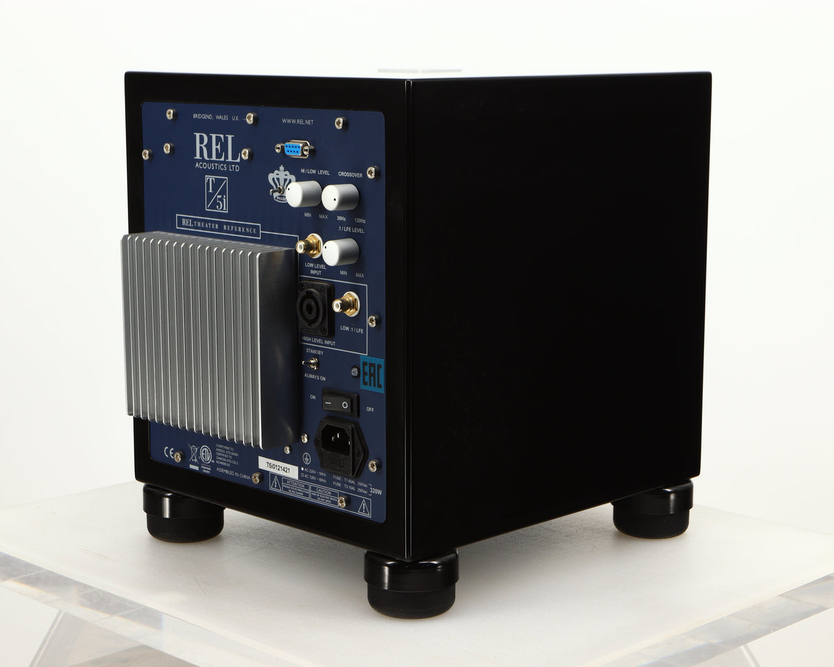 Rear left corner of a used REL T5i Subwoofer W/ Upgraded Feet in a piano black finish