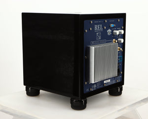Rear right corner of a used REL T5i Subwoofer W/ Upgraded Feet in a piano black finish