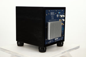 Rear left corner view of a used REL T5i Subwoofer in Piano Black finish with Upgrade Feet