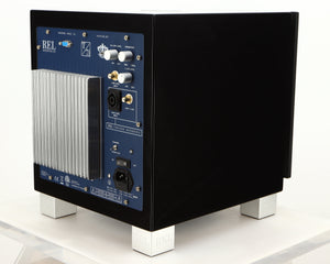 Rear left corner of a used REL T7i Subwoofer in a piano black finish