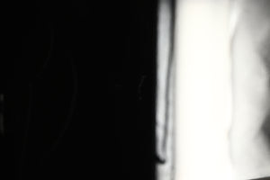 Close up view of a used REL T5X Subwoofer in Piano Black finish