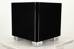 Front left corner view of a used REL T5X Subwoofer in Piano Black finish