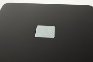 Close up view of a used REL T5X Subwoofer in Piano Black finish