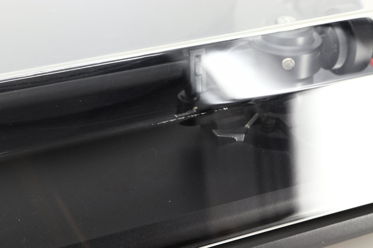 Close up of a used Revolver Rebel Turntable / AT95E Cartridge in a black finish showing some damage on the lid