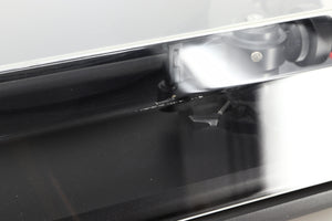 Close up of a used Revolver Rebel Turntable / AT95E Cartridge in a black finish showing some damage on the lid